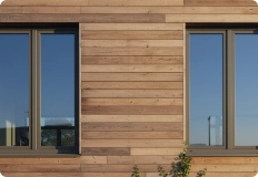 Energy efficient building exterior featuring insulation systems and high performance glazing